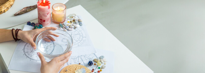 Ceromancy wax divination ritual with astrological charts, crystals, and runes on a table