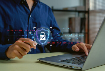 person using a laptop with a futuristic cybersecurity interface, highlighting data protection, secure access, digital privacy, and modern technology solutions for online security.