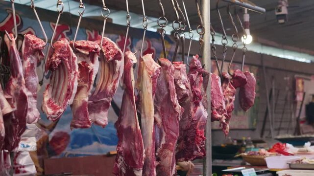 Fresh pork meat hung up in the vegetable market, pork meat hung up waiting for customers to buy