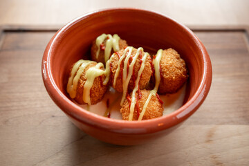 Crunchy snacks served in a rustic bowl at a vibrant culinary gathering