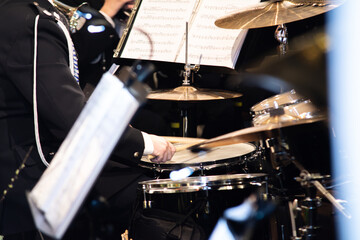 Drummer Playing Drums Percussion In Orchestra Concert Band With Sticks Creating Rhythm And Musical...