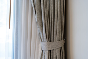 Room window with gray and light curtains