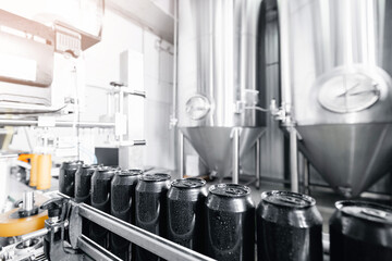 Modern beer factory with bottling line and stainless steel tanks