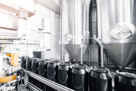 Modern beer factory with bottling line and stainless steel tanks