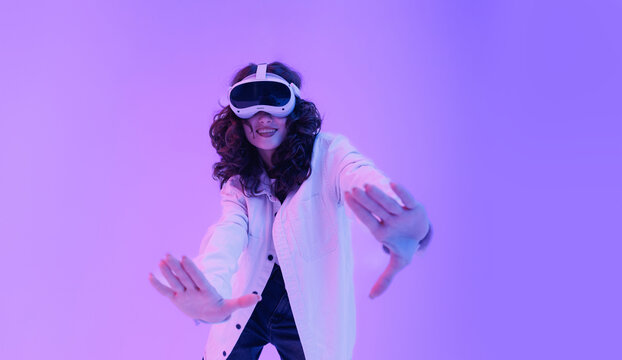 Innovation entertainment gadget with ai assistant. Asian young female experiencing virtual reality with headset and excited expression - Powered by Adobe
