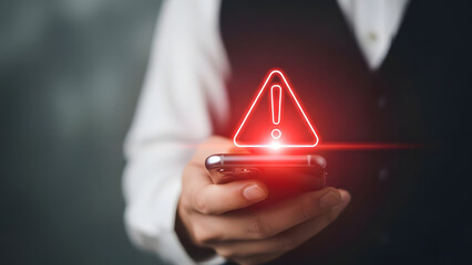 Man holding phone with red warning triangle alert symbol