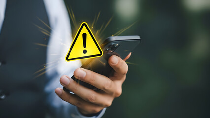 Man holding phone with warning sign overlay alert concept