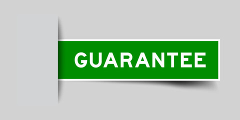 Green color square shape sticker label with word guarantee inserted in gray background