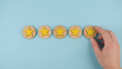 A hand placing a wooden star rating token on a light blue background, symbolizing feedback or review.