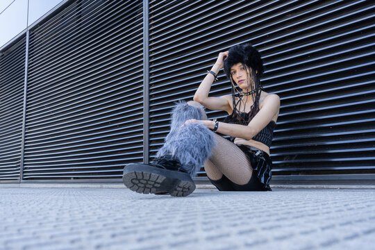Woman posing in alternative fashion with platform boots