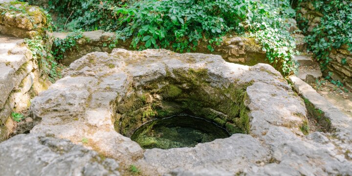 Small pool of water is sitting in a large rock