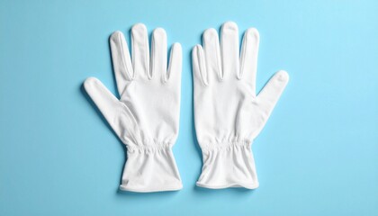 Obraz premium White Fabric Gloves with Gathered Cuffs on Light Blue Surface