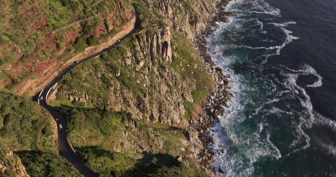 Aerial tilt up shot of Chapmans Peak Drive at sunset, Cape Town, Western Cape, South Africa.	
