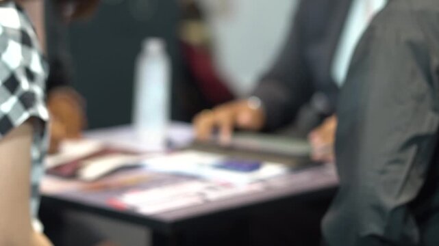 People are working on documents. Blurred focus. Slight shaking.