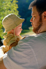 Father and Baby Relaxing in Sunny Park Copy Space