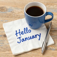 A cup of coffee and a napkin with the words hello january on a table