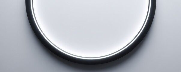 A minimalistic round light fixture with a sleek black rim, emitting a soft glow against a smooth white background.