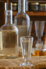 Horseradish tincture. Homemade strong alcoholic drink with horseradish and honey. Bitter. Rustic style. Selective focus