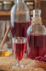 Cranberry tincture (liqueur). Homemade alcoholic drink with berries and spices with honey