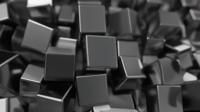 A grayscale close up of a pile of shiny metal cubes scattered randomly with reflections visible