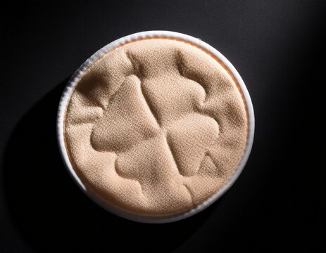 round reusable makeup remover pad on black background for eco friendly skincare solutions