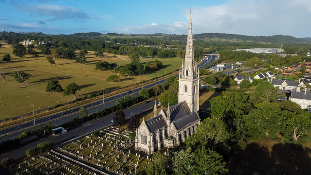 Aerial view showing St Margaret's Church with its surrounding graveyard and nearby countryside beside the A55 North Wales Expressway
