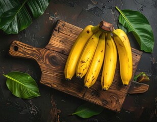 Bananas on wood cutting board with tropical leaves