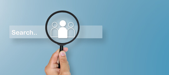  Business concept: Human Resources (HR) with a magnifying glass icon highlighting group icons within the search bar, representing recruitment, candidate selection, talent search, and employee.