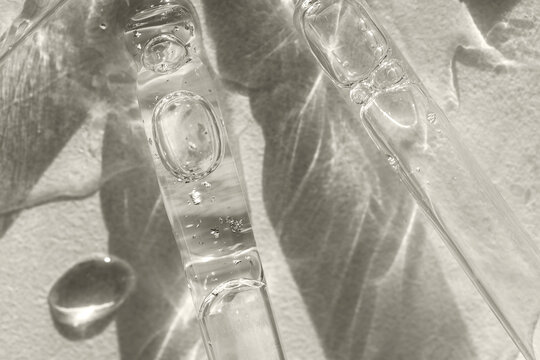 Close-up of glass pipettes with moisturizing serum with colloidal gold.