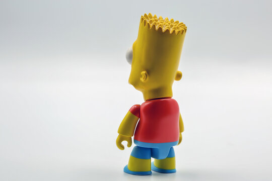 Bart Simpson toy figure half-turn from behind on white background.