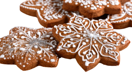 Close up of festive snowflake shaped gingerbread cookies with white icing isolated on transparent background