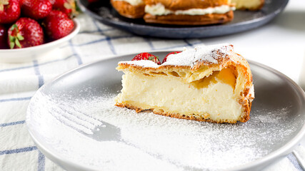Traditional Polish cake Karpatka on a gray concrete background.