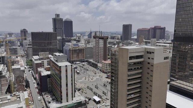 Drone rises up from outside Ghandi Square in downtown Johannesburg, South Africa on a sunny afternoon