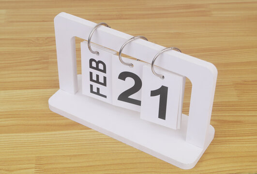 February, 21 on calendar on wooden table