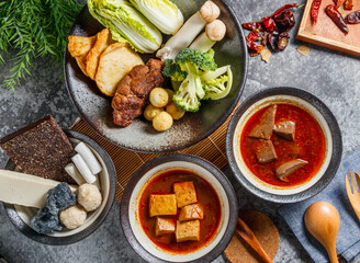 Delicious Asian hot pot ingredients and spicy broth bowls ready for an amazing flavorful meal