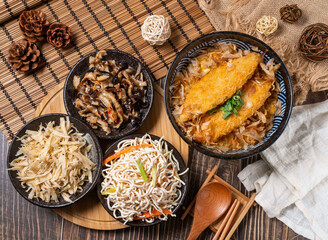 Delicious Asian meal featuring crispy fried fish over rice with savory side dishes beautifully arranged