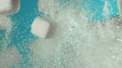 Cubes of sugar fly up and fall down on a blue background. Filmed on a high-speed camera at 1000 fps. High quality FullHD footage - Powered by Adobe
