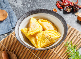 Golden savory egg dumplings served hot in a rustic bowl ready for a delicious Asian meal experience