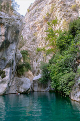 Stunning narrow Goynuk gorge with majesty of cliffs and turquoise waters. Dramatic rock formation towering over Goynuk canyon waters, Turkey.