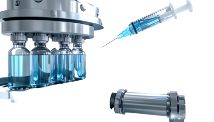 Close-up of medical vials, an injection, and a cylindrical medical device