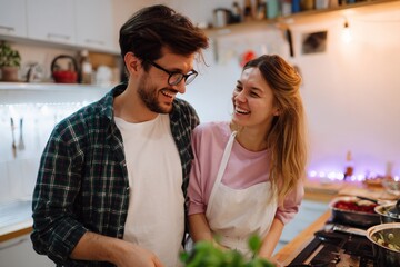 Happy couple cooking together in cozy kitchen setting