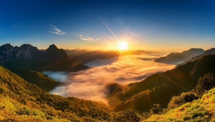 breathtaking sunrise over majestic mountain peaks with vibrant sun rays and soft fog in valley below
