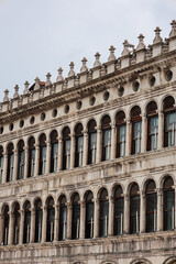 Fototapeta premium Detailed View of the Arched Windows and Intricate Renaissance Architecture of a Facade in Venice, Italy
