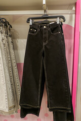 A demonstration of jeans in a modern clothing store.