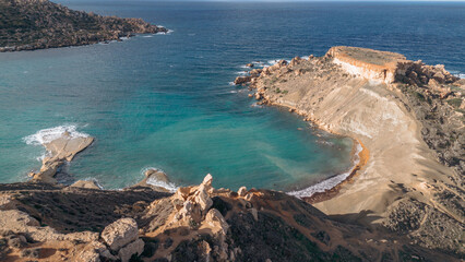 The azure Mediterranean Sea meets the rugged coastline of Malta.