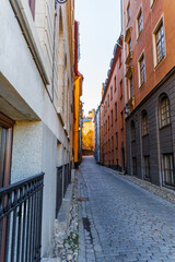 Historic stone alleyway with a steep incline and colorful medieval architecture