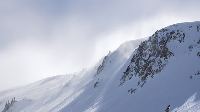 Snow-covered mountain peaks dusted with ice stand against a bright, overcast sky. Textures of rock and ice contrast with the soft, diffused light. A winter landscape.