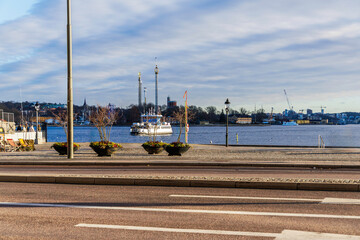 Stockholm waterfront with a ferry and amusement park rides in the background
