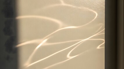 Sunlight creating wave-like reflections on an interior wall,Warm light reflects off the water in wave patterns on interior wall