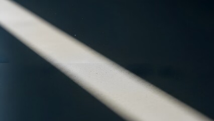 Abstract Beam of Light on a Textured Dark Surface, Modern Minimalist Still Life of Light and Shadow